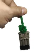 Kuchi traditional Rai Kirat chest ornament. Holding by hand to show the size reference